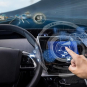 A hand uses a holographic car dashboard display showing speed, navigation, and nearby vehicles.